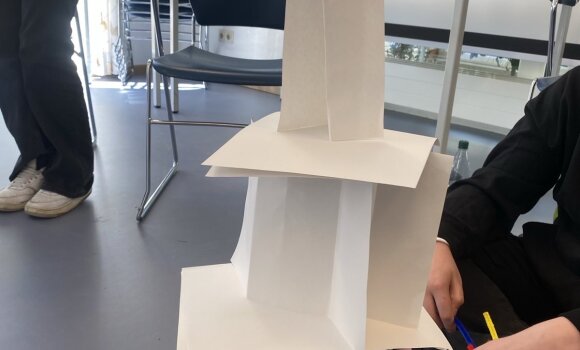 Zu sehen ist ein Turm, der aus verschiedenen Materialien zusammengebaut wurde. Hier hauptsächlich nur aus Papier. 